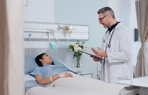 ConsultationBedAndDoctorWithPatientInHospitalForHealthcare