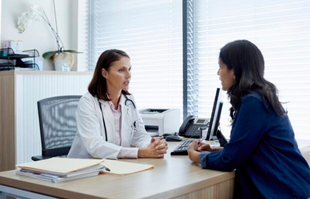 Doctor talking with female patient in clinic Yesil Science Doctor talking with female patient in clinic