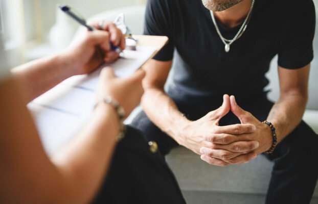 Man with psychologist theraphy social problems concept drug addiction talk to a psychological woman